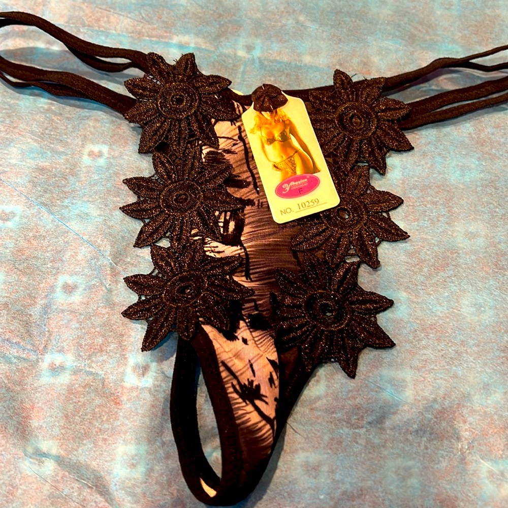 NWT size medium black thong with embroidery on front. Unique and beautiful